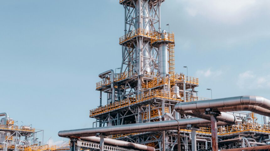 Industrial oil processing plant with piping against the sky