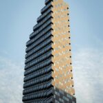 Tall residential condo apartment building with many windows against blue sky