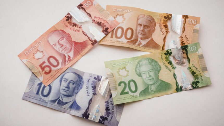 Canadian banknotes of several denominations fanned out on a surface