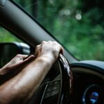 Hands on a car steering wheel