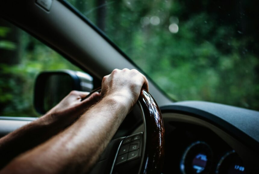 Hands on a car steering wheel