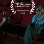 Diana Monea photographed in a theatre beneath a Calgary International Film Festival Official Selection 2026 laurel