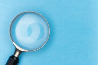 A magnifying glass resting on a white surface