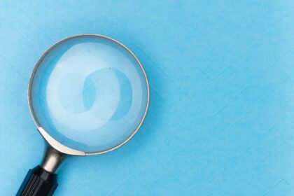 A magnifying glass resting on a white surface