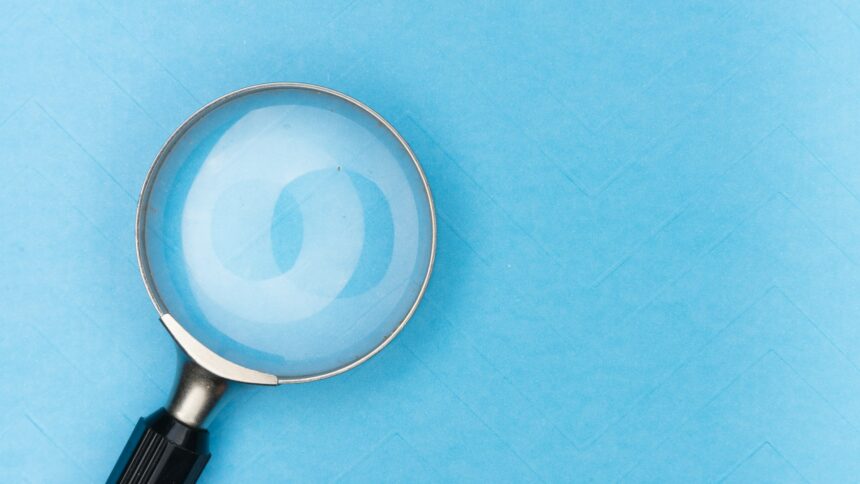 A magnifying glass resting on a white surface