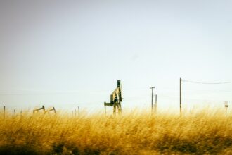 Oil pumpjack in a golden prairie field