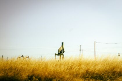 Oil pumpjack in a golden prairie field