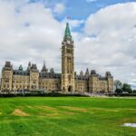 Parliament Hill and the Peace Tower in Ottawa under a cloudy sky