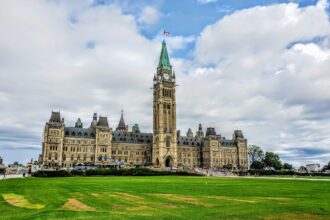 Parliament Hill and the Peace Tower in Ottawa under a cloudy sky