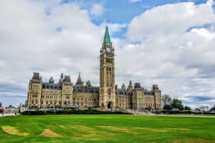 Parliament Hill and the Peace Tower in Ottawa under a cloudy sky