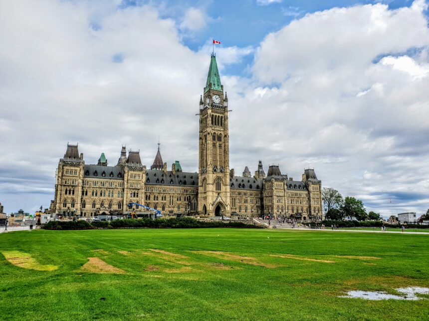 Parliament Hill and the Peace Tower in Ottawa under a cloudy sky