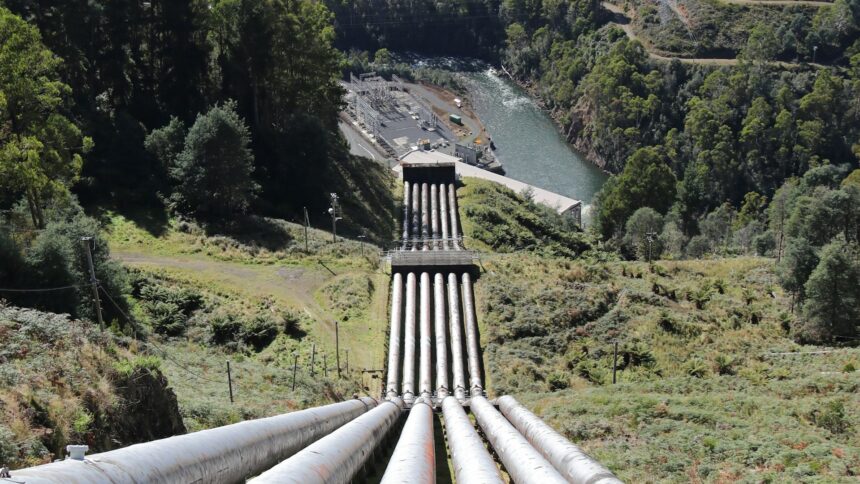 Sections of large diameter pipeline laid out across an open field
