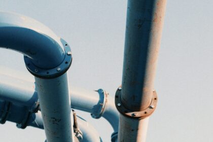 Large industrial pipeline valve and steel piping against an open sky