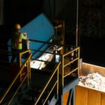 Worker sorting material at a recycling facility