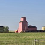 Colourful grain elevators against a prairie sky