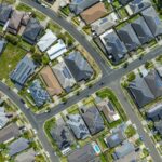 Aerial view of a suburban neighbourhood where many house roofs carry solar panels