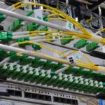 Fibre optic patch cables running into a network distribution panel
