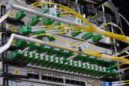 Fibre optic patch cables running into a network distribution panel