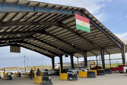 A road border crossing canopy with vehicle lanes beneath it