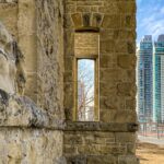 Weathered sandstone wall in Calgary with the Calgary Tower and downtown towers beyond