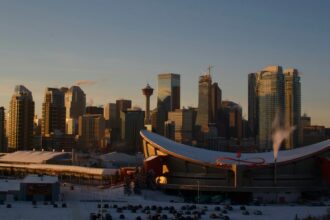 The Calgary skyline at dusk seen from Scotsman's Hill