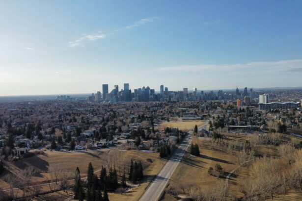 An aerial view across Calgary neighbourhoods toward the downtown skyline