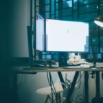 A computer monitor glowing in a dark office
