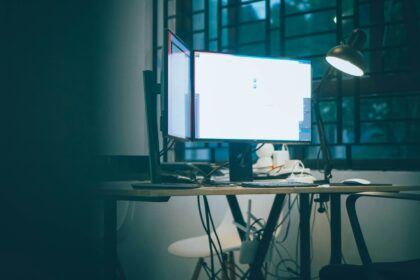 A computer monitor glowing in a dark office