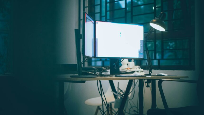 A computer monitor glowing in a dark office