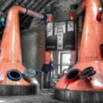 Two copper pot stills in a distillery
