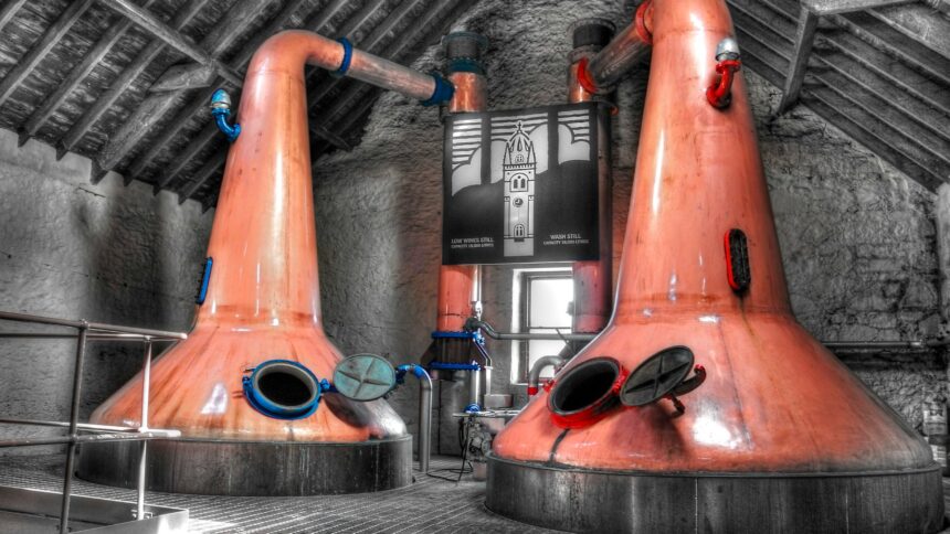 Two copper pot stills in a distillery