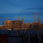 Tower cranes over wood-frame apartment buildings under construction