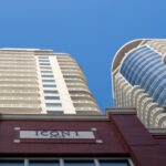 Curved residential condo towers against a blue sky in Edmonton