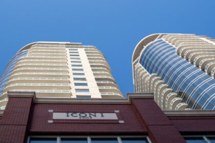 Curved residential condo towers against a blue sky in Edmonton