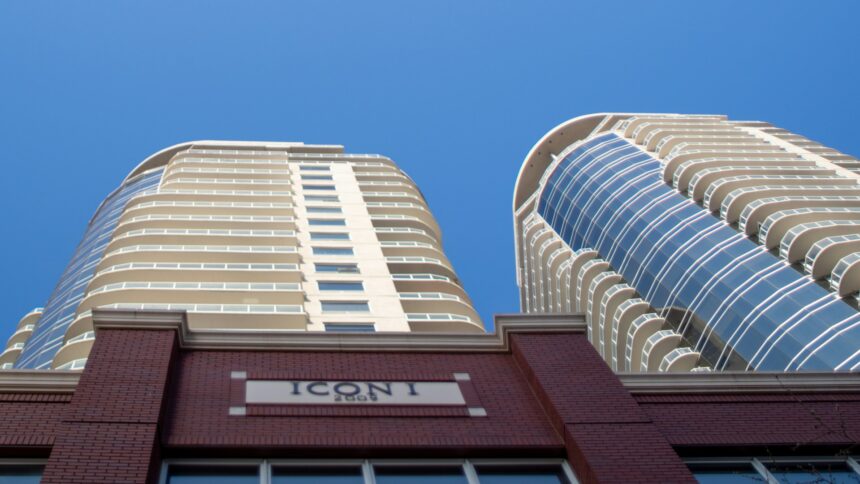Curved residential condo towers against a blue sky in Edmonton