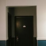 Closed bedroom doors along a narrow upstairs hallway