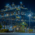 A large industrial gas processing plant lit up after dark