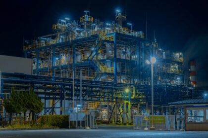 A large industrial gas processing plant lit up after dark