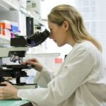 A researcher working at a medical laboratory bench