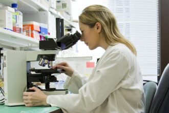 A researcher working at a medical laboratory bench