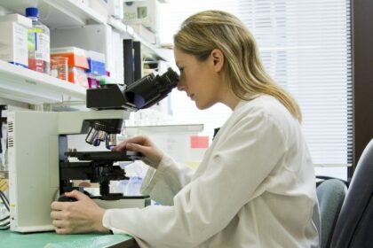 A researcher working at a medical laboratory bench