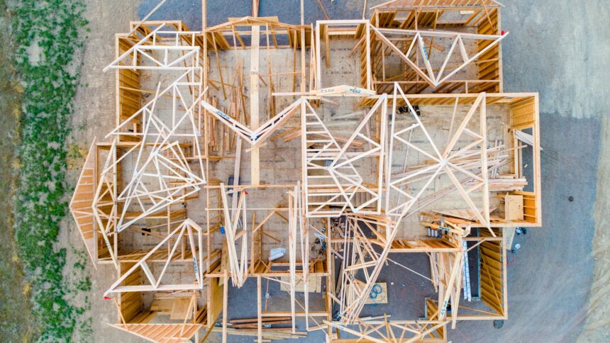 An overhead view of the wooden framing of a house under construction