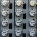 A household electric meter mounted on an exterior wall