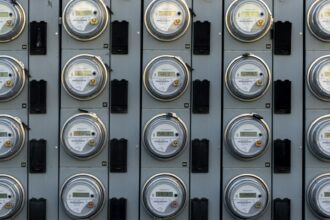 A household electric meter mounted on an exterior wall