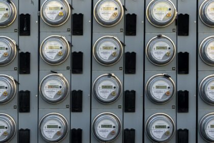 A household electric meter mounted on an exterior wall