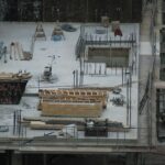 A snowy construction site with idle materials and equipment