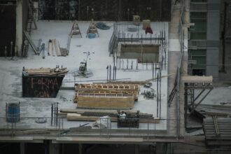 A snowy construction site with idle materials and equipment
