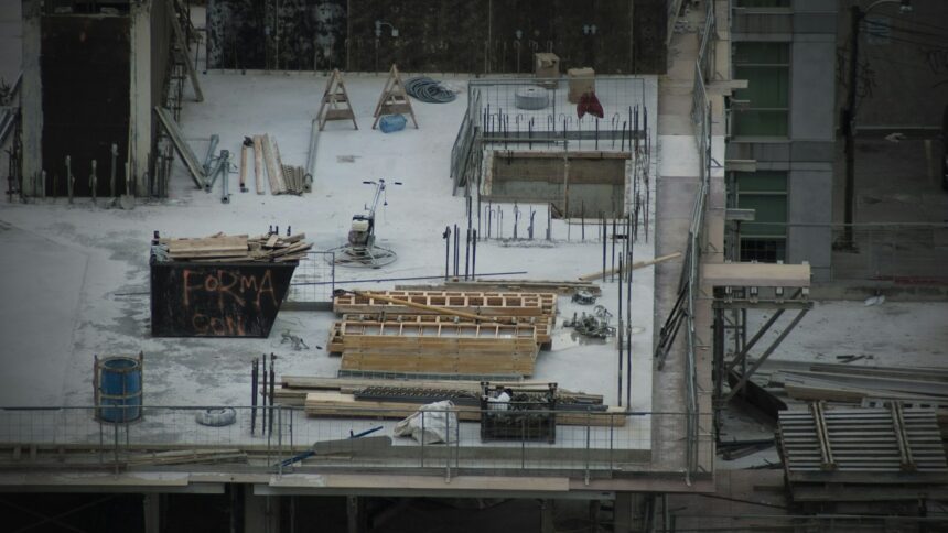 A snowy construction site with idle materials and equipment