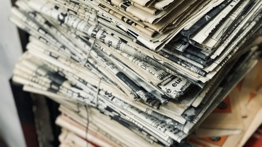 A stack of folded newspapers