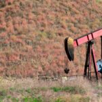 An oil pumpjack working in a rural field